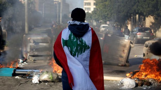 Un manifestante antigubernamental con la bandera del país.