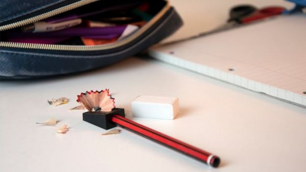 Child's home schooling desk with pencil case, pencil and paper - stock photo
