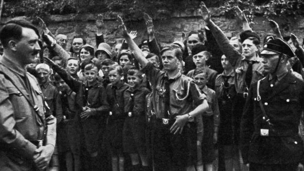 Adolf Hitler surveys young Nazi recruits.