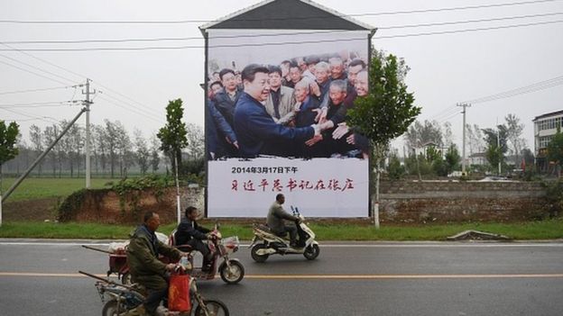 A poster of President Xi Jinping visiting people living in poverty