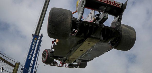 Kimi Raikkonen's car is removed by a crane