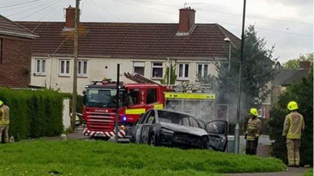 Car burnt out next to fire engine