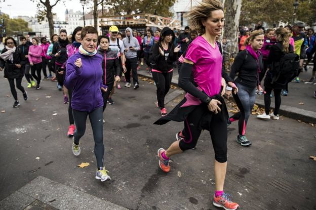 Women jog through Paris, 4 November