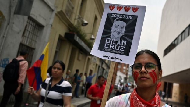 Una manifestante con un póster de Dilan Cruz.