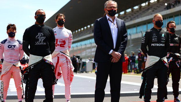 Stefano Domenicali stand next to Lewis Hamilton