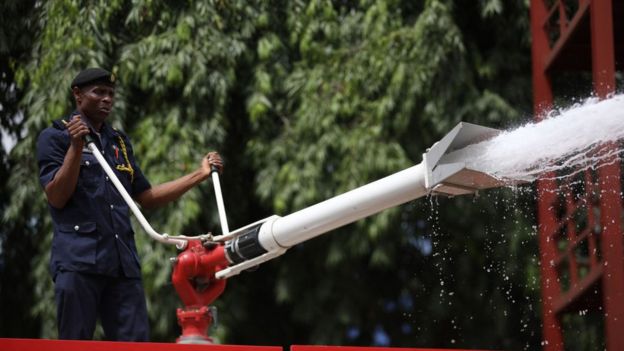 A law enforcement official sprays disinfectant in Abuja, Nigeria, on April 1, 2020.