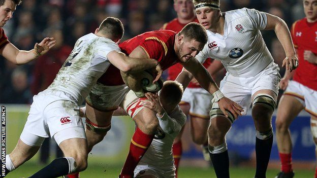 Harrison Keddie of Wales is tackled by George Worth and Mathew Protheroe