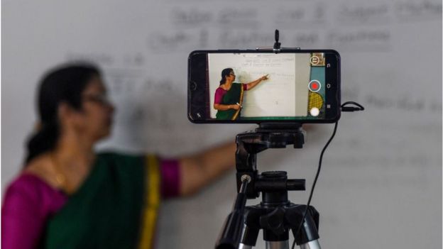 Aschool teacher gives a live streaming online class at a government school