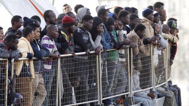 Migrants wait to disembark from a vessel in Sicily, southern Italy. Photo: May 2015