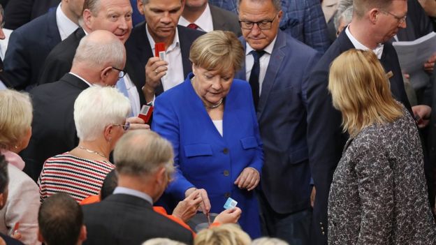 Parliamentarians, including German Chancellor Angela Merkel (C, in blue) cast their ballots to vote at the Bundestag on a new law to legalize gay marriage in Germany on June 30, 2017 in Berlin, Germany.