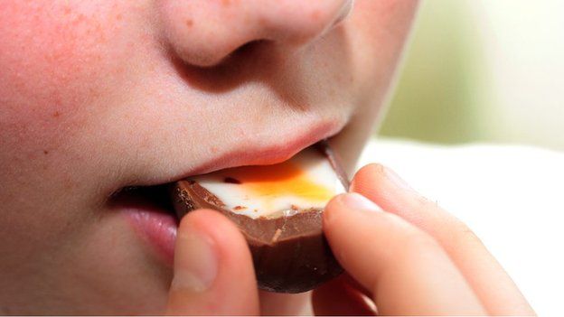 Boy eating a Creme Egg