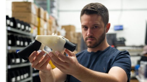 Cody Wilson, owner of Defense Distributed company, holds a 3D printed gun, called the 'Liberator', in his factory in Austin, Texas on August 1, 2018