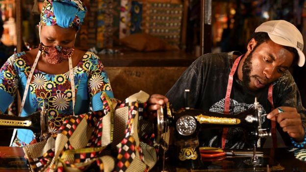 Tailors in Rwanda making traditional African fabric masks