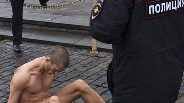 Performance artist Pyotr Pavlensky sits nailed to Red Square
