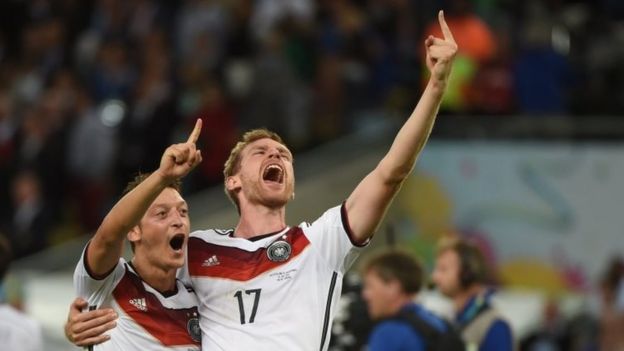 Mesut Ozil and Per Mertesacker celebrate after winning the 2014 World Cup final against Argentina in Brazil