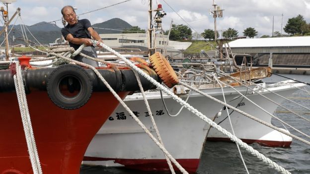 A fisherman tighten a rope to anchor his fishing boat with his colleague's boats in preparation for powerful typhoon Haishen in Makurazaki, Kagoshima Prefecture, Japan, 05 September 2020
