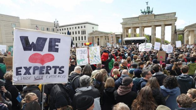 People gather in front of the Brandenburg Gate in support of scientific research during the March for Science in Berlin, Germany, 22 April 2017