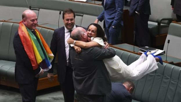MPs Warren Entsch and Linda Burney, from opposite sides of politics, embrace after the vote