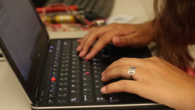 The pink markers on Maysie's laptop offer a tactile reference point from which she can better orientate herself