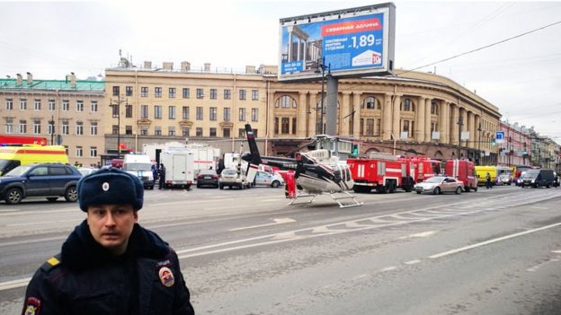 Emergency vehicles and a helicopter are seen at the entrance to Tekhnologichesky Institut metro station in Saint Petersburg on April 3, 2017