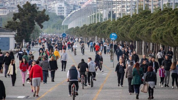 Crowd of thousands of people are seeing walking and running at the popular for locals and tourists New Promenade of Thessaloniki on 27 April