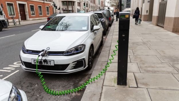 An electric car is seen charging at a charging point on the street in Westminster, central London, UK on January 11, 2019