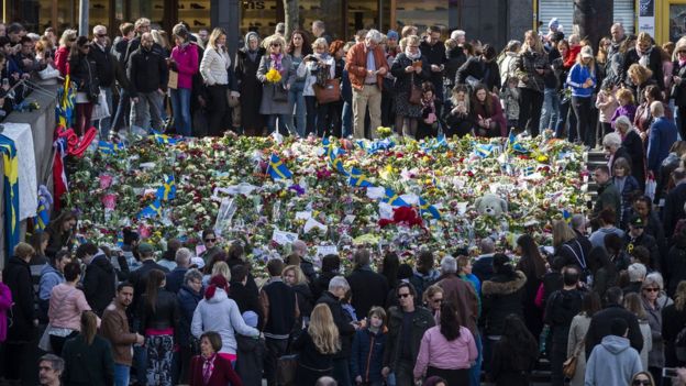 People gather on the stairs of Sergelstorg plaza to pay their respects on April 9, 2017 in Stockholm, Sweden