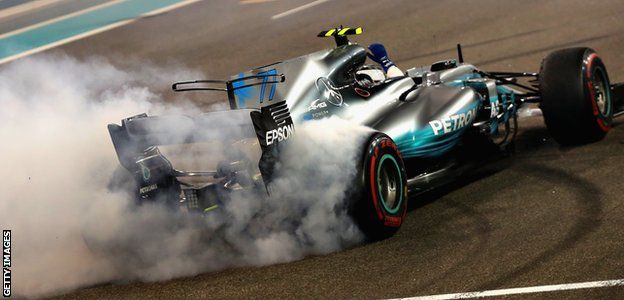 Race winner Valtteri Bottas celebrates with donuts on track during the Abu Dhabi Grand Prix