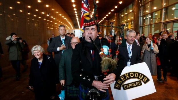 Brexit Party MEPs leaving the European Parliament led by a man playing the bagpipes