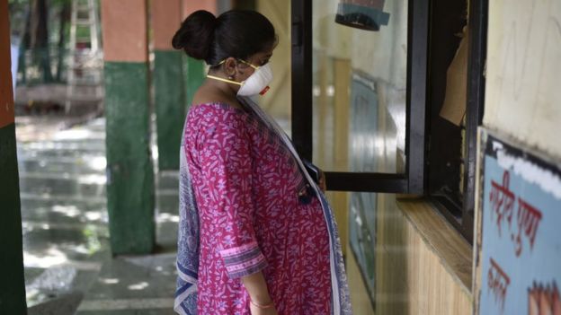 A pregnant woman waits in front of the registration window for a Covid-19 test, at a centre in the MCD primary school at Turkman Gate on June 24, 2020 in New Delhi, India.