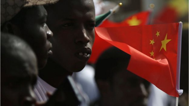 Well wishers holding flags wait for the arrival of Chinese President Xi Jinping at the Leopold Sedar Senghor International Airport at the start of his visit to Dakar, Senegal July 21, 2018.