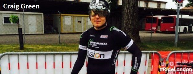 Craig Green, wearing a cycle helmet, sun visor holding is bike on a race day