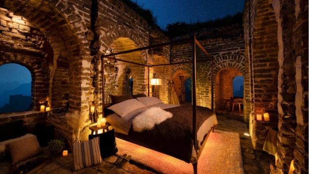 a bed in a stone room