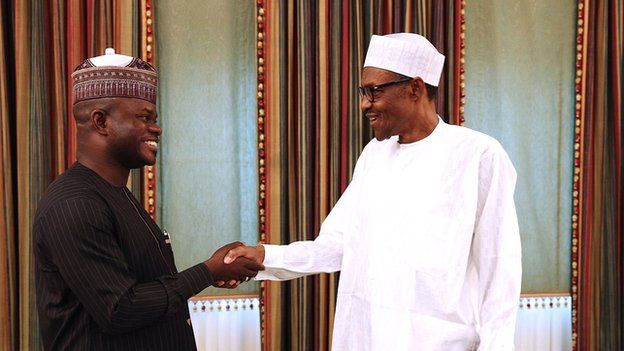 Yahaya Bello and Muhammadu Buhari dey shake hands