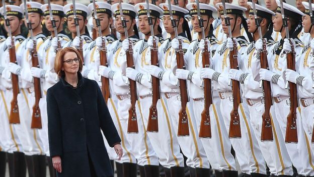 Julia Gillard walks by assembled Chinese soldiers during a welcome ceremony on an official visit to Beijing in 2013