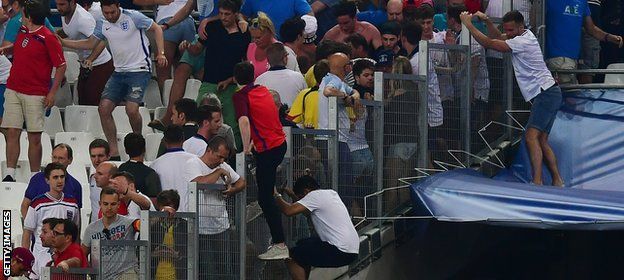 England fans jump barriers to get to safety in the match against Russia