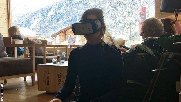 Laurenne sitting down is from our team hotel in St Mortiz at the 2017 World Ski Championship she's watching the Downhill course the afternoon before the race (she finished 5th). She is using a Samsung phone and HMD.
