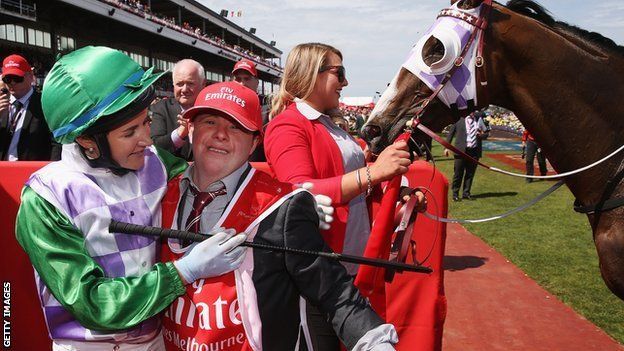 Michelle Payne celebrates her winning ride on Prince Of Penzance to win race 7 the Emirates Melbourne Cup with brother and strapper Stephen Payne