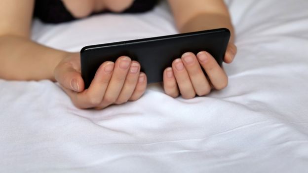 Woman watching porn on a smartphone