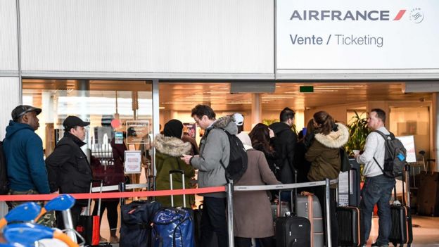 Grupo de pessoas em aeroporto da França