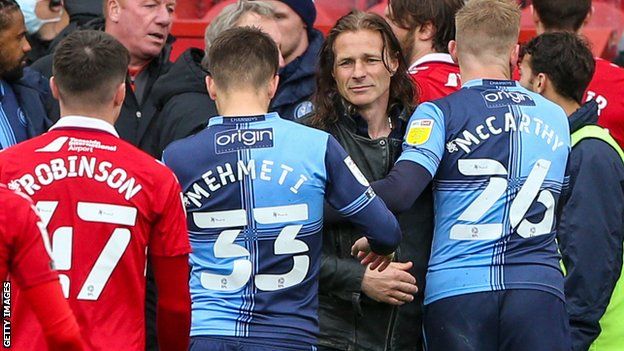 Wycombe boss Gareth Ainsworth consoles his players