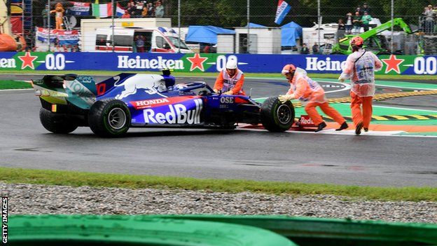 Marshalls help Pierre Gasly after the Toro Rosso driver spins during first practice