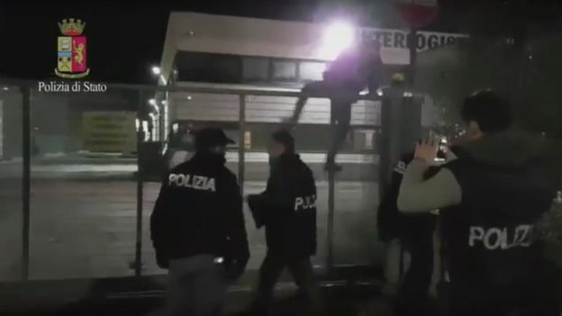 Screen grab of video shows Italian police entereing a depot