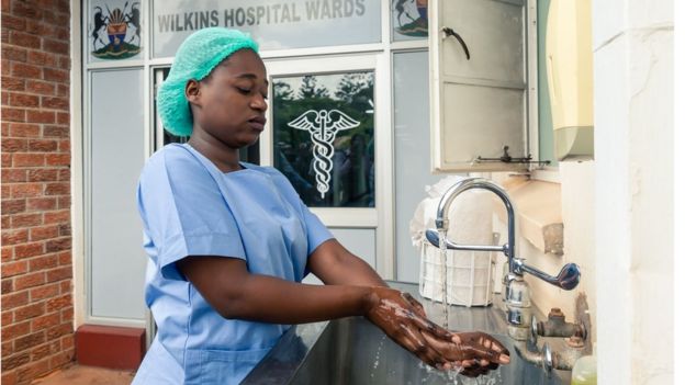 A medical staff member washes her hands at the Wilkins Infectious Diseases Hospital in Harare on March 11, 2020