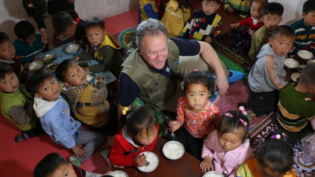 David Beasley rodeado de niños