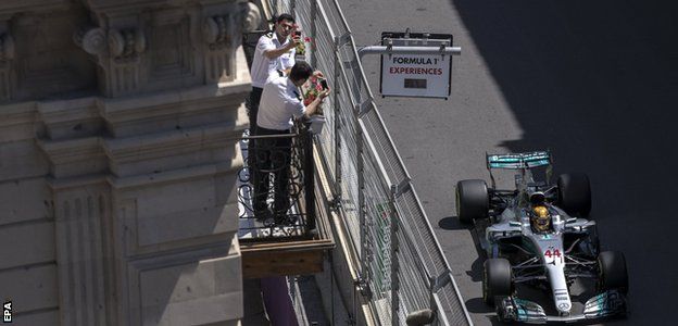 Fans take pictures of Lewis Hamilton