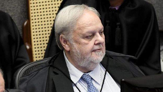 O ministro Felix Fischer de toga e sentado em sala de tribunal