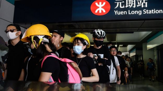 Protesters line up inside an MTR station in the Yuen Long district of Hong Kong on July 27, 2019, before an expected protest march in the afternoon.