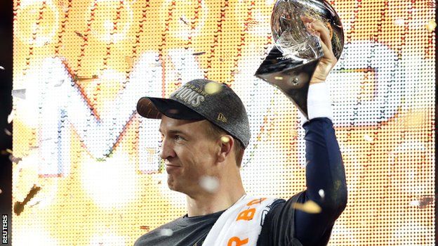 Peyton Manning holds the Vince Lombardi trophy