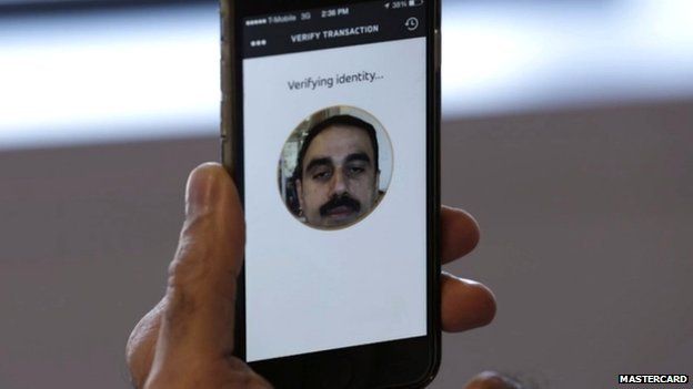 Ajay Bhalla demonstrating facial recognition